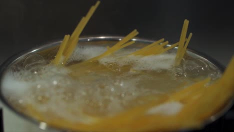 Spaghetti-Boiling-in-a-small-sauce-pan-close-up-slow-motion