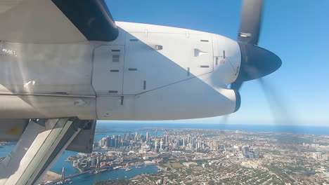 Aircraft-preparing-to-land-extending-landing-gear-on-approach-to-Sydney-Airport-flying-over-Sydney-Harbour-Australia