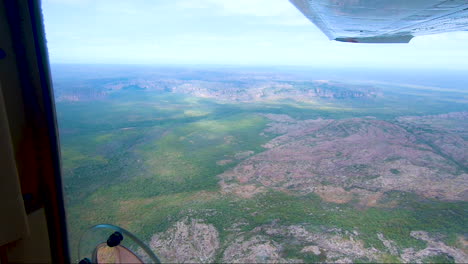 Light-aircraft-flying-towards-river-valley-Kakadu-National-Park-Northern-Territory-Australia