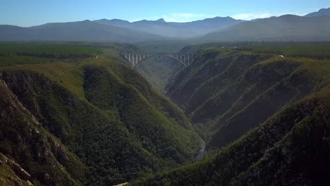 Beautiful-Scenic-Bloukrans-Bridge-Soaring-Over-River---Valley,-Africa,-Aerial-Pull-Back-Reveal-Motion