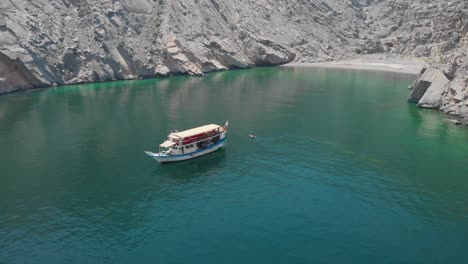 Aerial-shot-from-drone-of-a-dhow-cruise-in-Gulf-of-Oman,-Khasab
