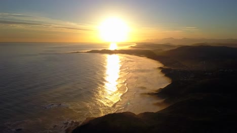 Big-Stunning-Orange-Sunset-over-South-African-Coast,-Knysna,-Aerial-Drone-Left-Motion