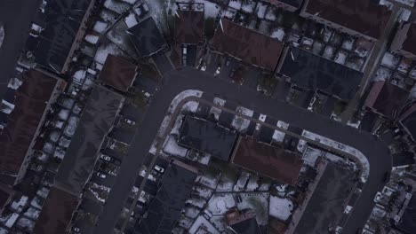 Dynamic-Aerial-Rotating-Bird-Eye-View-Drone-shot-of-neighbourhood-district-during-cold,-snowy,-winter-day