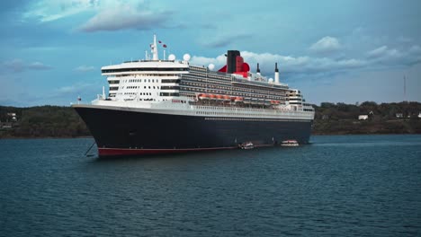 Rotating-view-from-the-sides-to-the-front-of-Queen-Mary-two-transatlantic-ocean-liner-parked-on-the-ocean