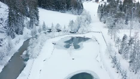 Aerial-view-of-a-frozen-pond-in-San-Vigilio,-Italy