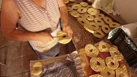 Cutting-fresellas-in-half-before-baking.-Calabria,-Italy