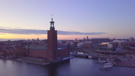 Stockholm-City-Hall-drone-pull-away-view-at-evening-time