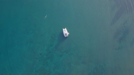 Drone-point-of-interest-view-of-yatch-in-blue-sea-water-in-tropical-island-on-a-sunny-day