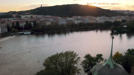 Aerial-View-Of-River-Vltava-In-Prague-With-Sunset-Skies-In-Background
