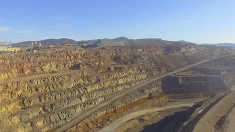 Heavy-machinery-working-in-the-Riotinto-open-pit-copper-mine-aerial-shot