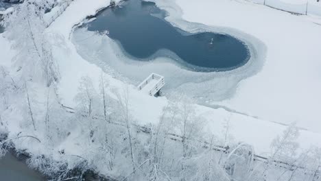 Aerial-view-of-a-frozen-lake-in-South-Tirol,-Italy