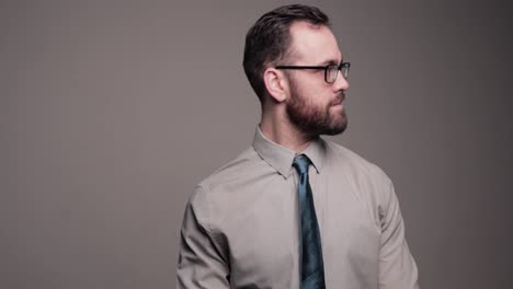 Bearded-man-uncomfortably-adjusted-tie-and-looks-around,-medium-shot