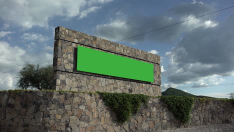 Green-screen-billboard,-rustic-construction,-wide-shot,-clouds-background