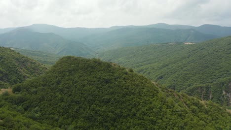 Aerial-view-flying-over-forested-mountains-and-valleys-in-Georgia