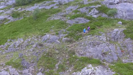 Couple-climbing-a-mountain-aerial-shot