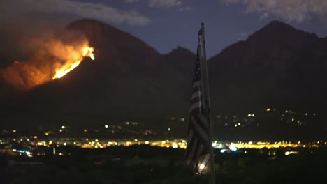 Wildfire-on-Hills-at-Night-in-Background-of-American-National-Flag