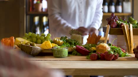 Preparing-fresh-fruit-platters-for-wedding-guests-in-a-New-Zealand-winery---wide-pan