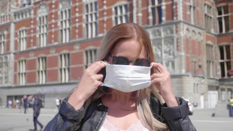 Lovely-Dutch-Woman-With-Sunglasses-Wears-Face-Mask-In-Amsterdam,-Netherlands---close-up,-slow-motion