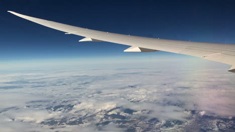 Boeing-airplane-wing-in-flight-over-the-clouds