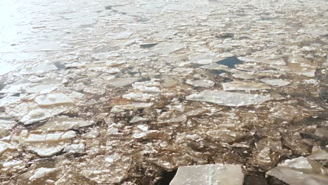 Aerial-panoramic-view-of-cracked-ice-floes-floating-in-the-sea