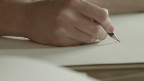 A-woman-uses-a-pencil-to-make-a-sketch
