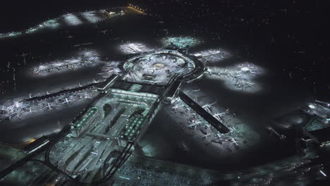 Aerial-view-of-a-large-airport-hub-at-night