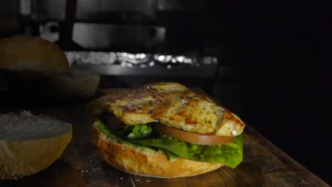 Grilled-chicken-breast-falls-on-burger,-slow-motion