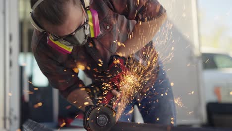 Professional-craftsman-worker-grinding-metal-with-flying-sparks,-slowmo