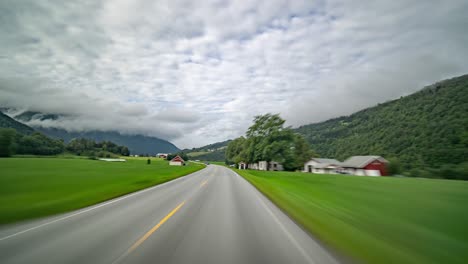 A-drive-along-the-country-road-65,-in-the-valley-of-the-Surna-river,-Norway