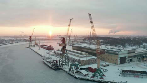 Aerial-view-of-industrial-port-in-winter,-covered-with-show,-frozen-water