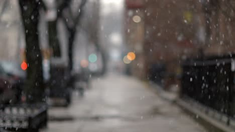 Dreamy-Snow-Blizzard-snowflakes-falling-down-Brooklyn-street-in-front-of-bokeh-street-lights---Detail-shallow-focus-shot
