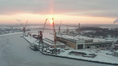Aerial-view-of-industrial-port-in-winter,-covered-with-show,-frozen-water