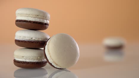 A-macaroon-slides-across-a-surface-past-a-stack-of-macaroons