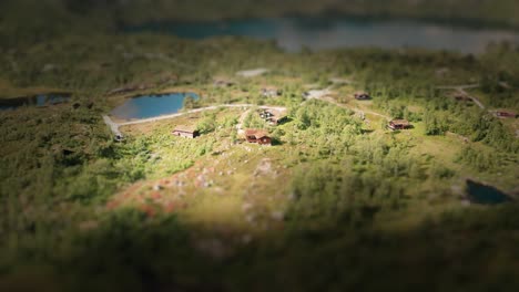 A-miniature-Norwegian-village-seen-from-bird's-eye-view-located-on-countless-slopes-covered-with-coniferous-trees-and-stones