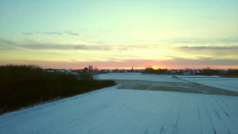 tilt-up-when-the-sun-is-setting-over-snow-covered-field