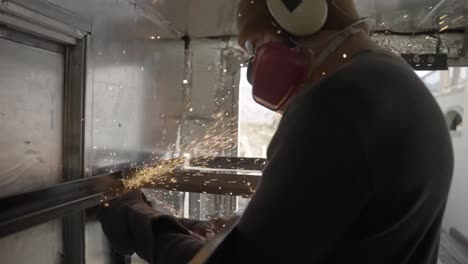 Professional-metal-worker-grinding-steel-with-angle-grinder,-slow-motion