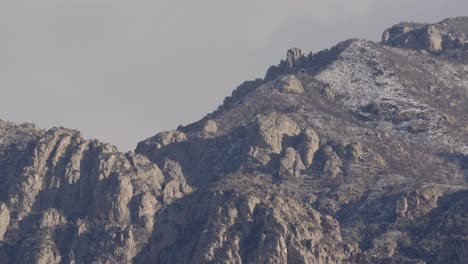 Mountain-range-ridge-line-with-soft-warm-lighting,-close-up-telephoto-shot