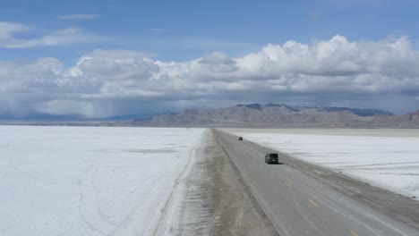 Cars-on-Desert-Road-in-Famous-Bonneville-Salt-Flats,-Utah---Aerial