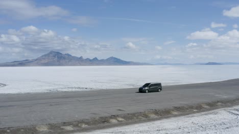 Car-with-Epic-Salt-Flats-Scenic-Background---Utah,-Aerial-Orbit