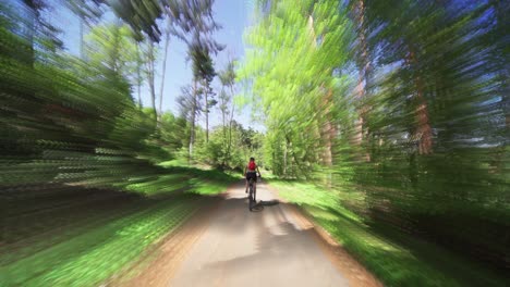 The-rear-view-of-the-female-cyclist-riding-a-bicycle-in-the-Divoka-Sarka-natural-reserve-in-Prague-on-a-sunny-summer-day