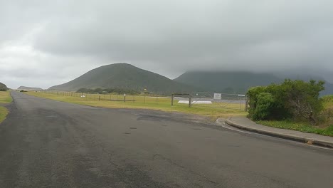 Driving-along-Lagoon-Rd-Lord-Howe-Island-passing-by-the-local-airport-on-a-rainy-overcast-day