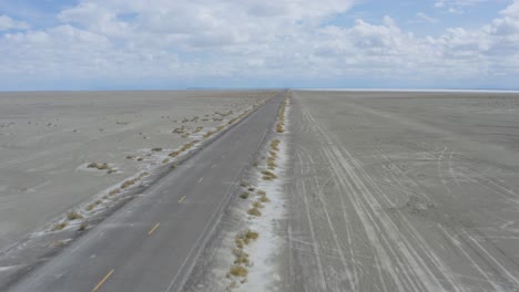 Open-Road-in-Vast-Empty-Desert-Landscape-with-Copy-Space-in-Sky,-Aerial