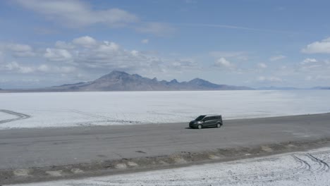 Car-on-Road-in-Epic-Landscape-of-the-Utah-Bonneville-Salt-Flats,-Aerial