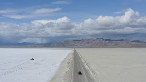 Car-Traveling-Fast-on-Road-Trip-in-Desert-Salt-Flats-Road,-Aerial-View