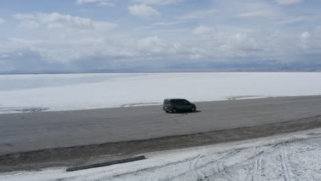 Car-Parked-on-Road-in-the-Vast-Desert-Wilderness-of-the-Bonneville-Salt-Flats-in-Utah,-Aerial-Orbit