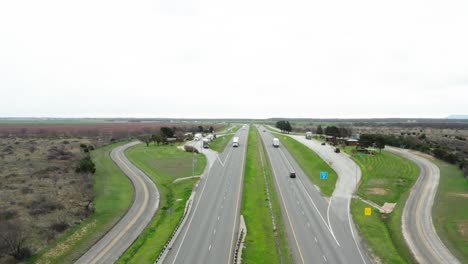 Semi-truck-parking-lot-on-highway-side-in-aerial-drone-view,-USA
