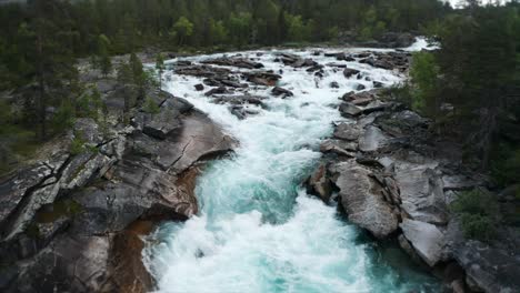 Mesmerizing-sight---the-powerful-flow-of-wild-water-rushing-in-the-narrow-rocky-riverbed,-foaming,-splashing,-forming-whirlpools-and-eddies-on-its'-way