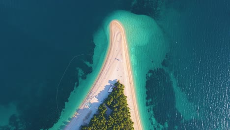 Drone-flight-over-the-coastal-strip,-trees,-and-the-beach-in-the-resort-town-of-Croatia-on-the-shores-of-the-Adriatic-Sea