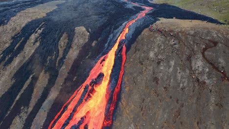 River-Of-Lava-Flowing-Down-A-Cliff-During-Fagradalsfjall-Eruption-In-Iceland---aerial-drone-shot