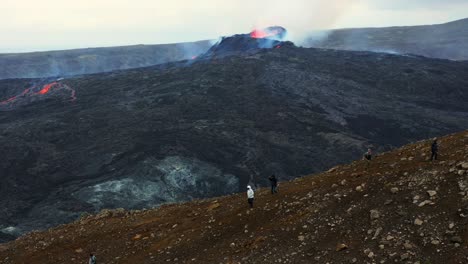 Tourists-Watching-The-Fagradalsfjall-Volcano-During-Eruption---aerial-drone-shot